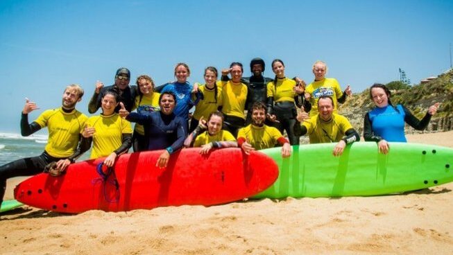 people posing for a photo with surfboard at Hostel & Surfcamp 55 in Ericeira