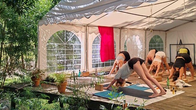 people doing yoga with a garden at Maceda Surf Camp in Porto Portugal
