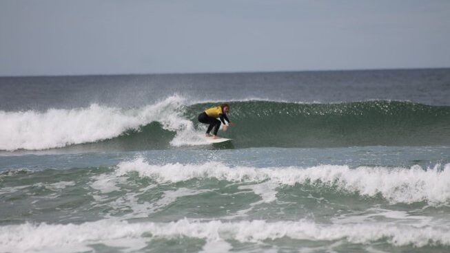 a surfer learning how to surf at Marias Hostel & Surf camp in Porto Portugal