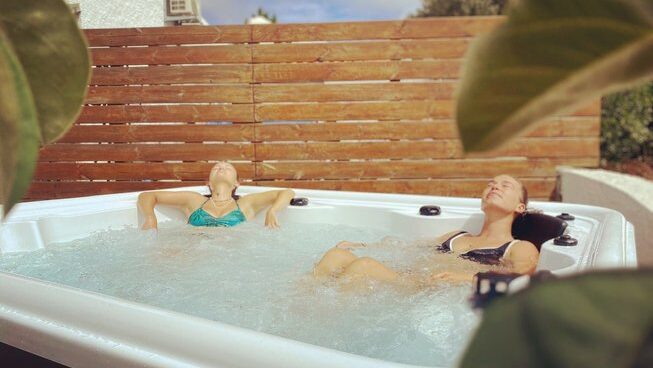 Two people in a jacuzzi at Moka Surfhouse & Yoga Retreat in Ericeira