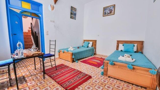 Accommodation with two single beds and colourful at Naneakite Surf Camp in Essaouira Morocco