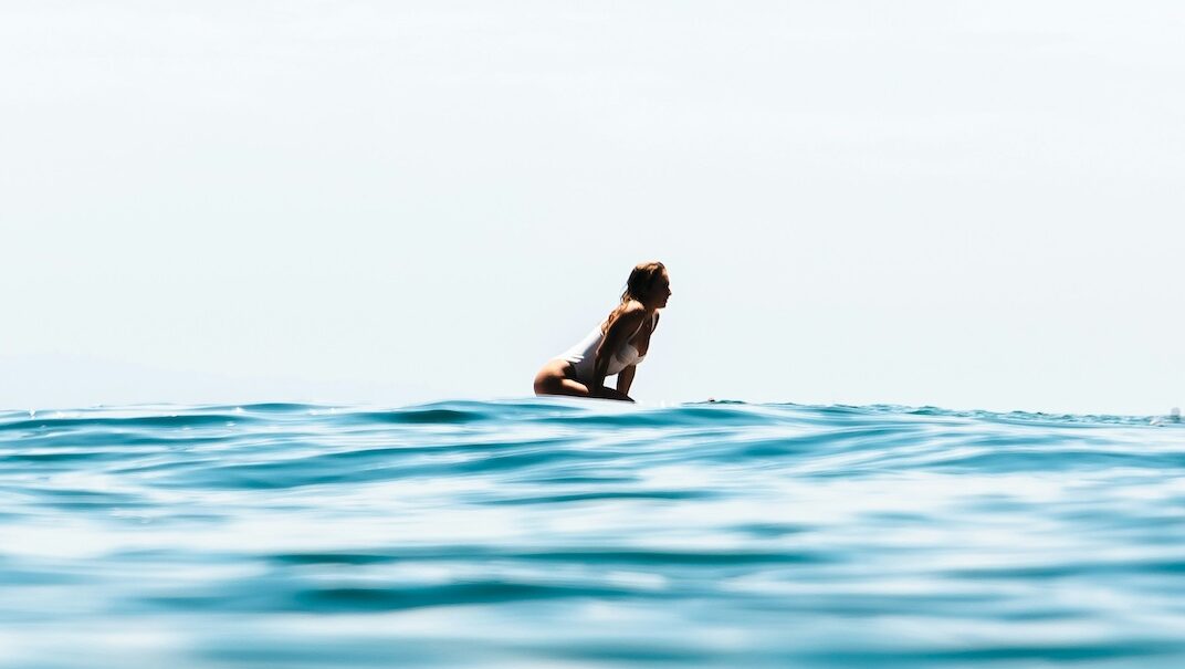 a girl on a surfboard at a Peniche surf camp