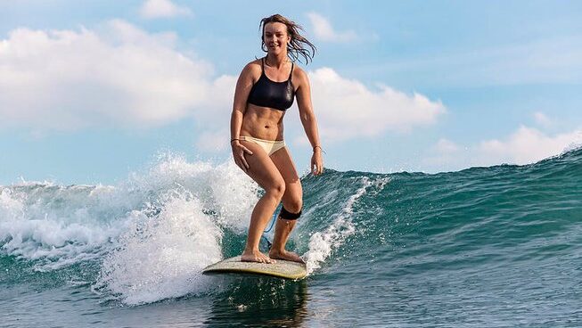A surfer on a wave at Pura Vida Surfers surf camp in Santa Teresa