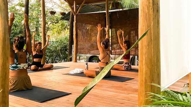 a group of people doing yoga at Pura Vida Surfers surf camp in Santa Teresa