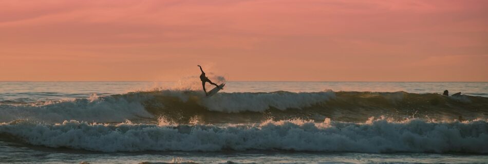 A guy doing an aerial while surfing at Santa Teresa Costa Rica surf camp