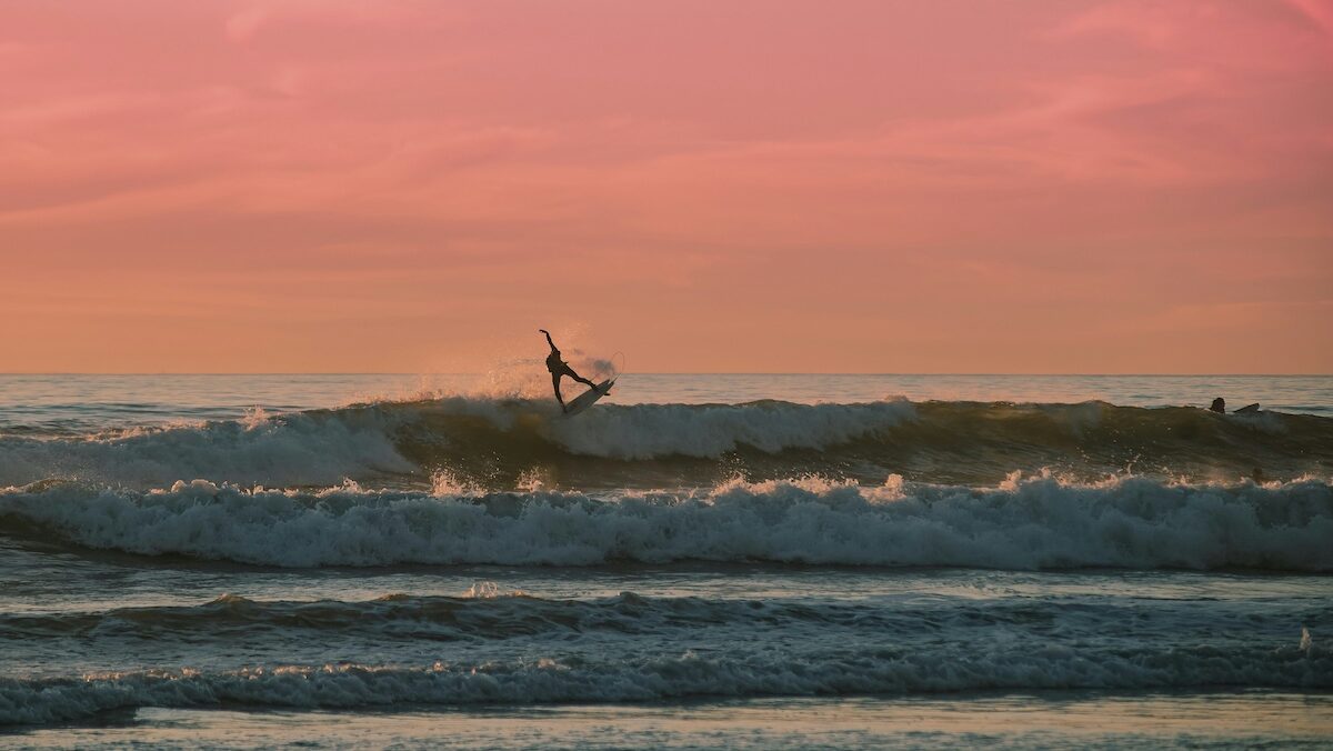 A guy doing an aerial while surfing at Santa Teresa Costa Rica surf camp