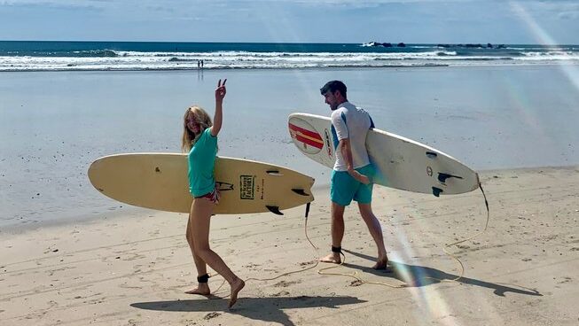 people walking to the surf with surfboards Shambala Retreats surf camp Nosara, Costa Rica