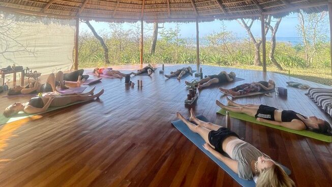 people laying down after a yoga session at Shambala Retreats surf camp Nosara, Costa Rica