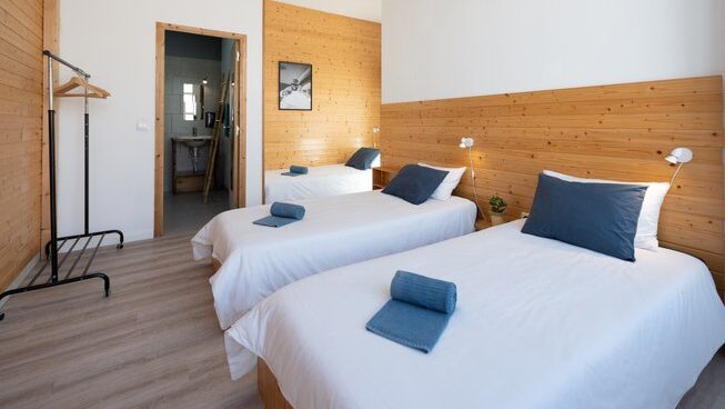 accommodation with three beds at Shark’s Lodge surf camp in Peniche Portugal