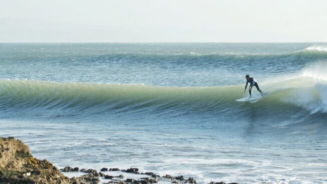 a surfer riding a wave at Surf Camp Essaouira Morocco