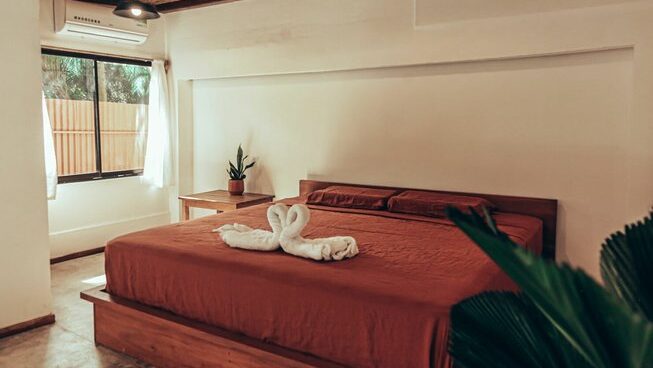 queen bed at accommodation at Surf Camp Zeneidas surf camp in Santa Teresa