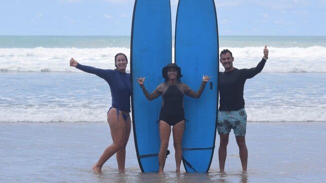 two people and an instructor learning how to surf at Surf Camp Zeneidas surf camp in Santa Teresa