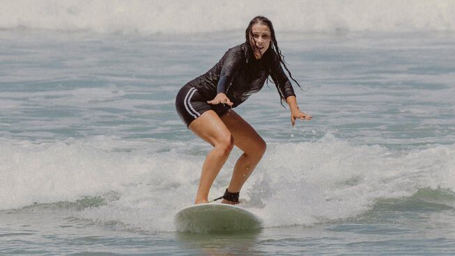 a learner surfer riding a wave at Surf Camp Zeneidas in Santa Teresa