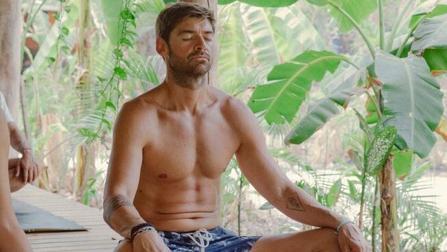 a guy in a yoga pose at Surf Camp Zeneidas surf camp in Santa Teresa