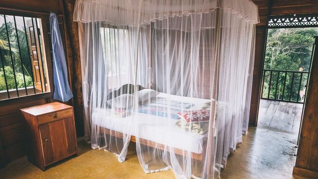 accommodation of bed with mosquito net at Surf & Yoga Mirissa surf retreat