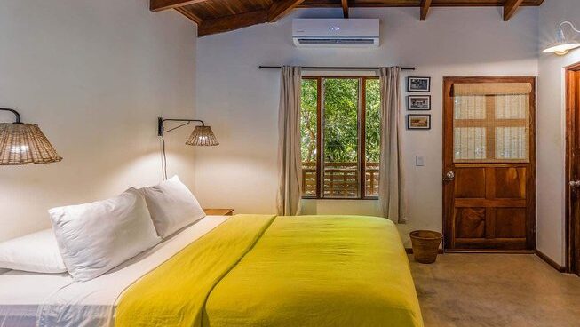 Accommodation and queen bed at Surfari Surf School in Nosara Costa Rica