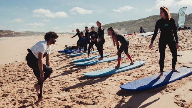 surfers learning how to stand on the sand at Surfcamp 360 surf camp