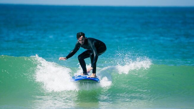 a surfer riding a small wave at Surfcamp 360 surf camp