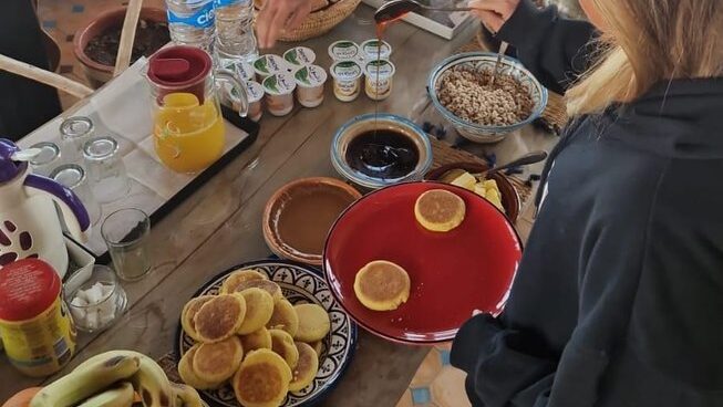 Breakfast served on a plate with pancakes and juice The Petit Surfer Imsouane surf camp