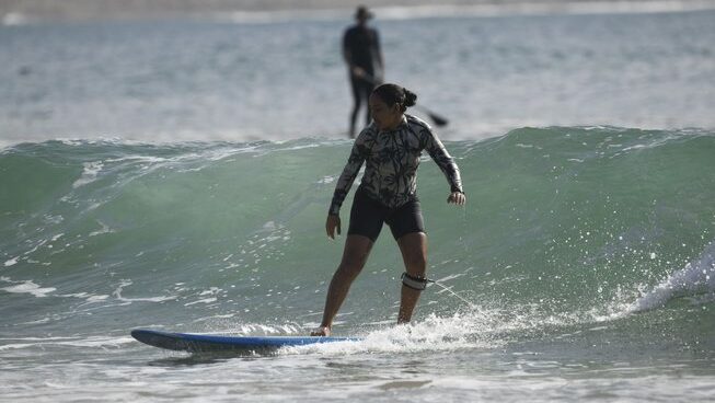 a learner surfer riding a wave with The Petit Surfer Imsouane surf camp