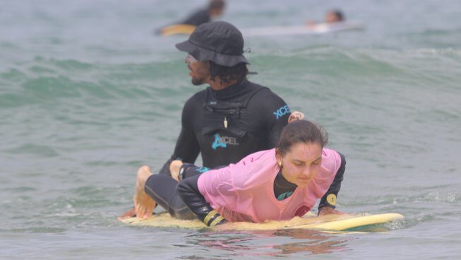 a learner surfer with an instructor The Petit Surfer Imsouane surf camp