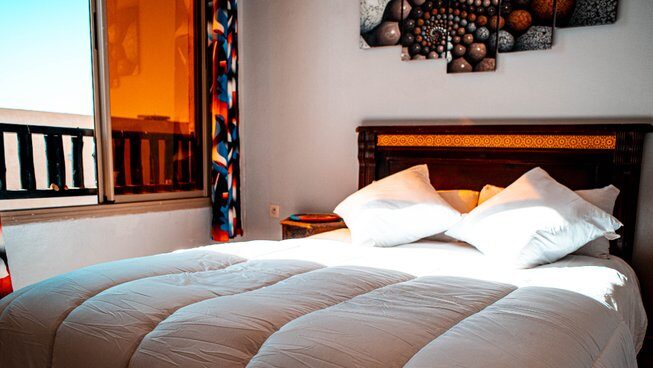Accommodation and the queen bed of The Petit Surfer Imsouane surf camp