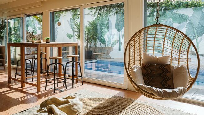 accommodation with egg chair and pool at The Salty Pelican surf camp in Ericeira