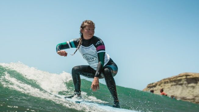 A surfer on a wave at The Salty Pelican surf camp in Ericeira