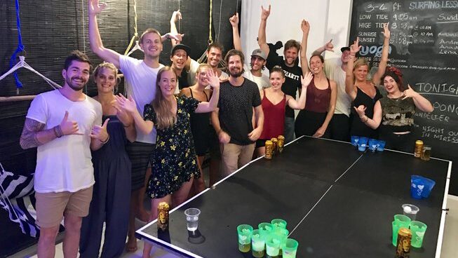 A group of people playing beer pong at The Surfer Weligama surf camp