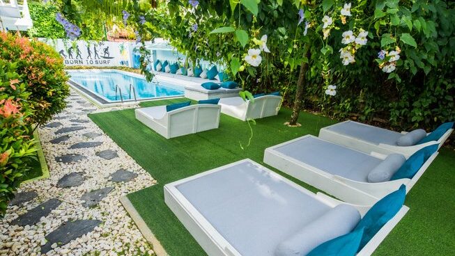 Sun beds and pool at The Surfer Weligama Surf Camp