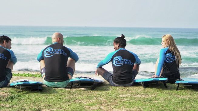 A group of surfers stretching at The Surfer Weligama Surf Camp