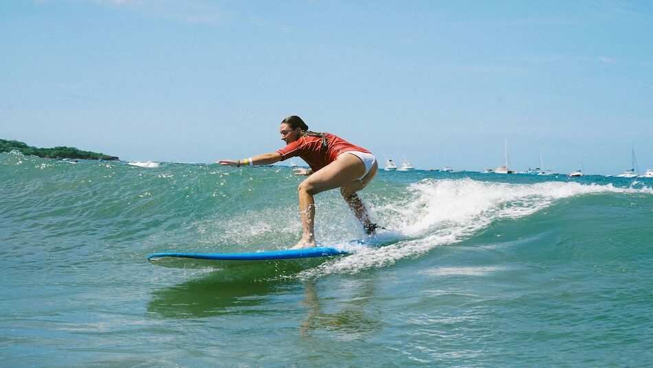 A surfer learning how to surf at a best Costa Rica surf camp for beginners