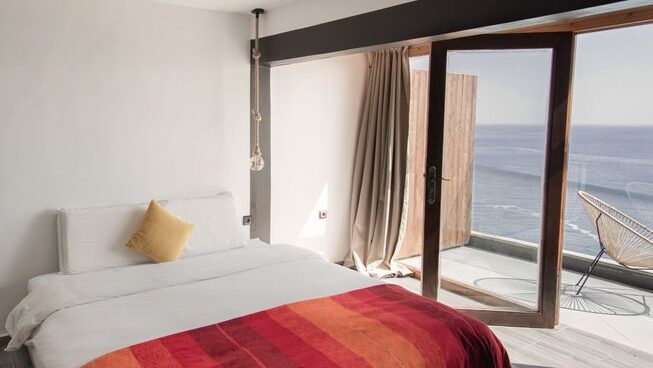 Bed and balcony at Allride Surfer surf camp Taghazout