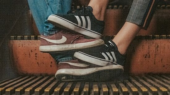 One pair of Adidas shoe and one pair of nike shoes together