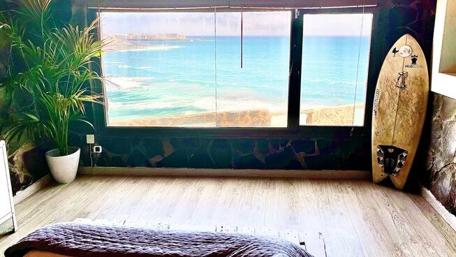 Window with a beach view at Accommodation with ping pong table at High Voltage Adventure surf camp
