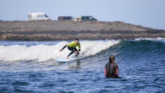 A surfer learning on a wave with Homegrown surf camp