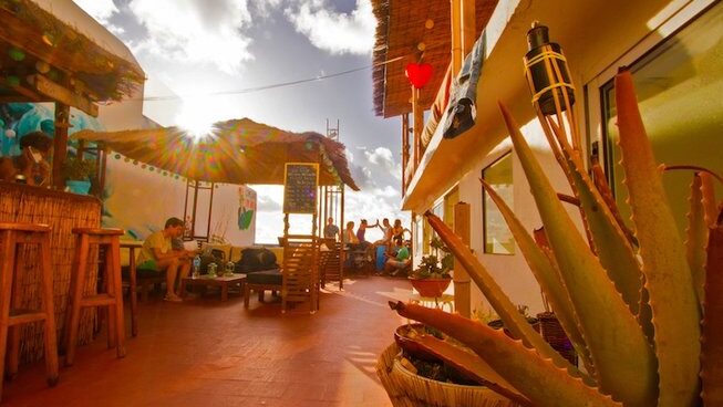sun setting with people sitting outside at Oceanside Gran Canaria Surf camp
