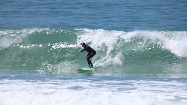 a person surfing on a wave at Sand Surf Morocco surf camp