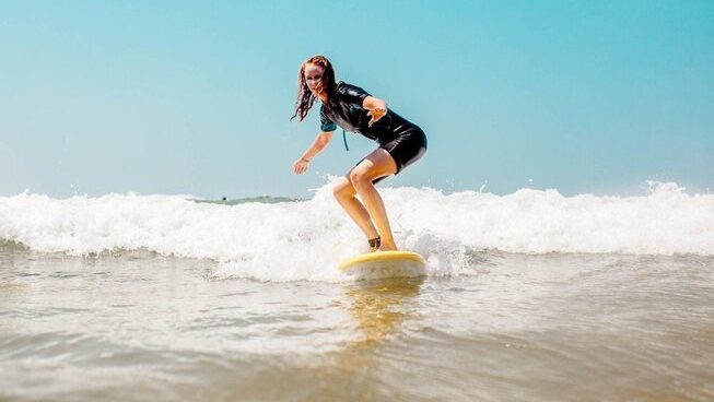A learner surfer riding a wave at Sand Surf Morocco surf camp