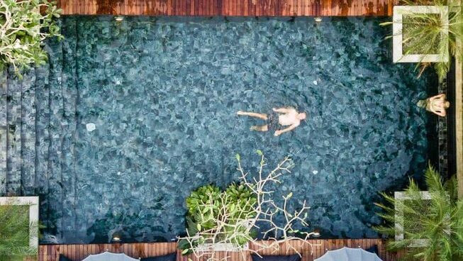 drone shot of a pool with someone swimming at Solid Surf and Yoga House Sri Lanka surf camp in Weligama