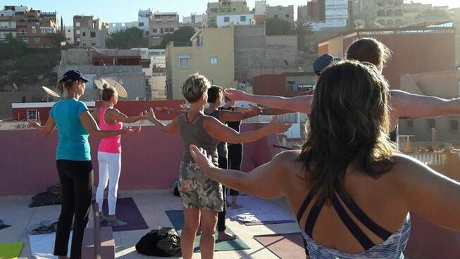 people doing yoga on a terrace at Surf Paradise Morocco surf camp