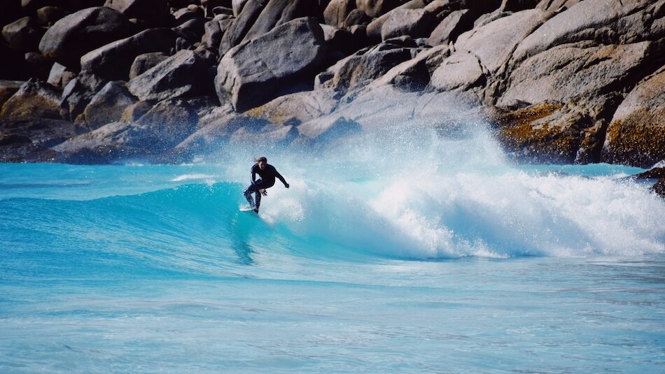 A surfer on a blue wave