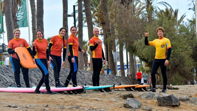 Surfers learning how to surf on the beach with Endless Summer Vibes surf camp