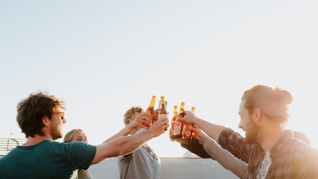 People cheers with beers at Endless Summer Vibes surf camp