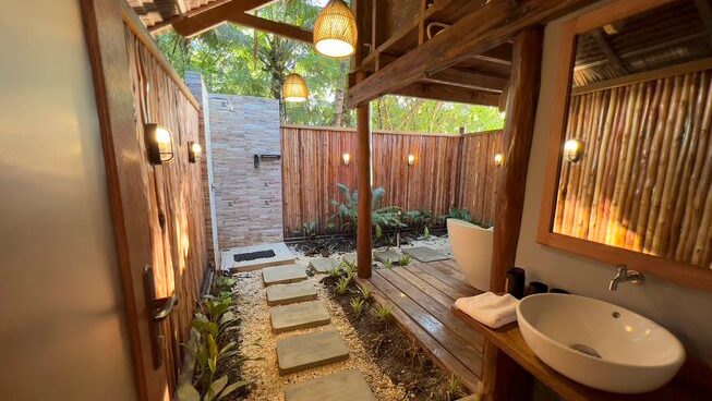 outside shower with bathroom at Hidden Bay Resort Mentawais