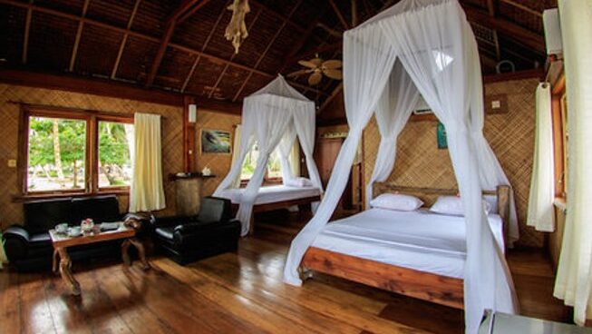 Kingfisher Mentawai accommodation with bed and mosquito nets