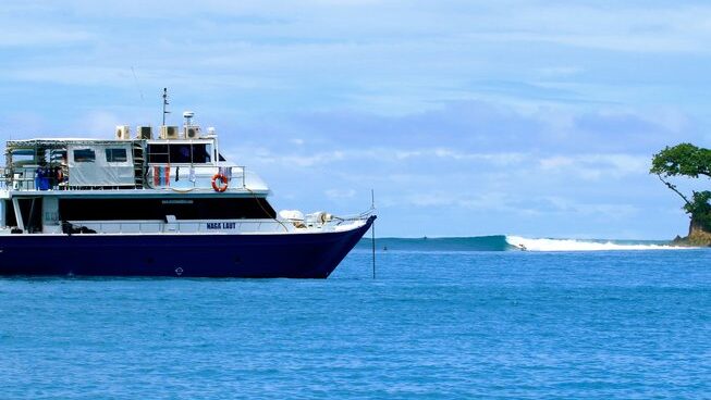 Boat and surf break with Naga Laut surf camp