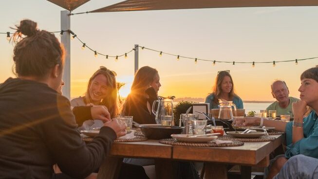 people hanging out at sunset at The Salty Surf and Yoga surf camp