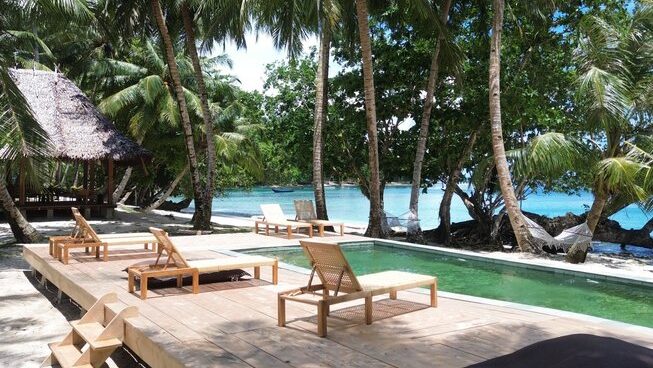 Accomodation and pool with chairs at VAYA Mentawai