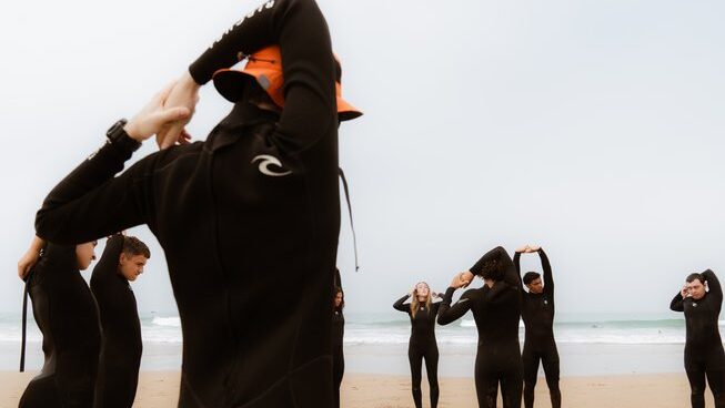 stretching on the beach before surfing with Anamar Surf Morocco